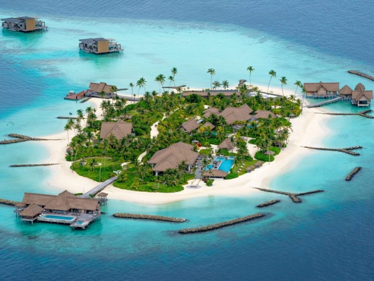 Sea-level in the Maldives, shown by the low-lying Waldorf Astoria Maldives, surrounded by sea water in different shades of turquoise