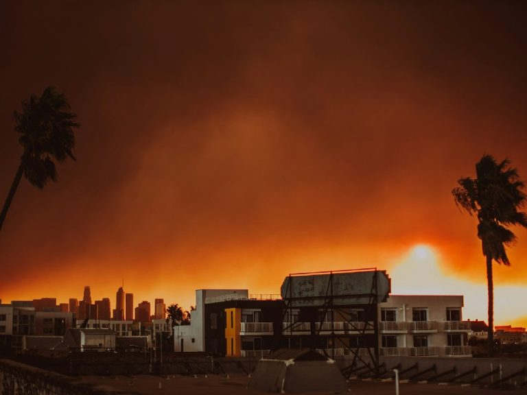 A large plume of smoke is seen over Los Angeles in Koreatown during the Palisades wildfire in January 2025.