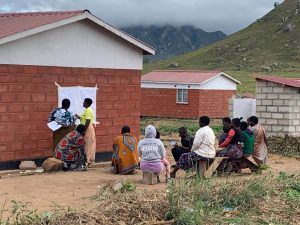Participatory group work in Chikwawa district, Malawi. Drawing on paper to visualise a house and discussing what represents the meaning of ‘home’.