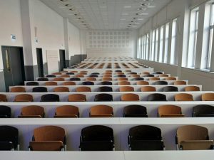 Empty lecture hall with rows of seats at the Budapest University of Technology and Economics, Műegyetem rakpart, Hungary. Photo by Zsófia Hajnal via Unsplash
