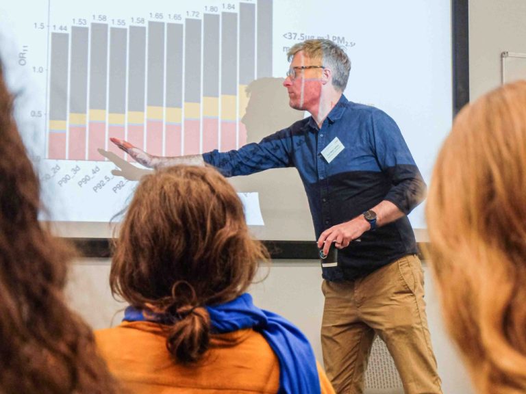 Backs of audience heads as they watch a seminar session at the Critical Decade for Climate Action Conference at the University of East Anglia (UEA) in September 2025