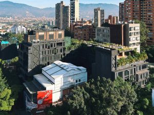 Bright day cityscape of Medellín, Colombia featuring modern architecture and created green spaces to provide shading: a useful element of climate adaptation planning in cities